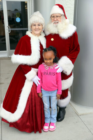 Mrs. Claus and Santa Claus with a little girl outside the mall. (Mark Haynes, Discover Clarksville)